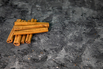 Cinnamon sticks on a black background.