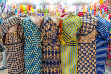 Six colorful African fabrics presented as dresses on mannequins in Mozambique