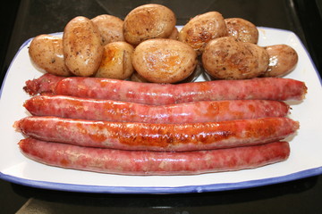 Sausages and potatoes baked in the oven