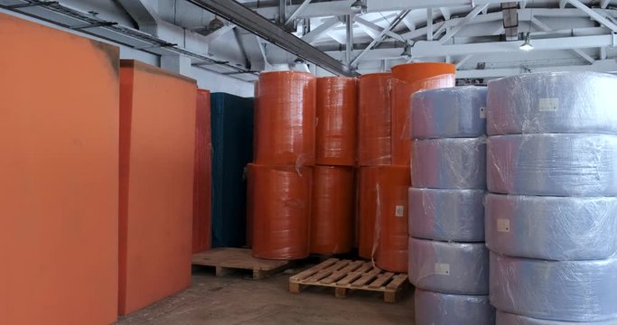 In huge warehouse, paralon in cubes and rolls, synthetic materials for production of hygiene products and mattresses, multi-colored raw materials, sponges, production, spacious and dry warehouse