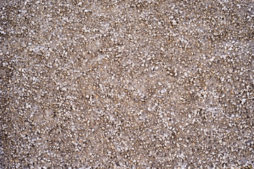 Texture of a part of the wall made of concrete with stone crumbs. Structure.