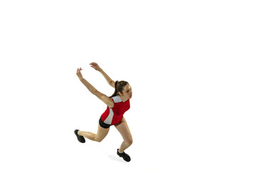 Fototapeta na wymiar In jump and flight. Young female volleyball player isolated on white studio background. Woman in sportswear and sneakers training, playing. Concept of sport, healthy lifestyle, motion and movement.