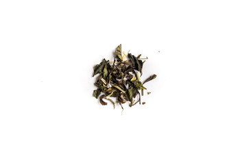 different sorts of black or green tea in bulk  on a white background close-up isolated
