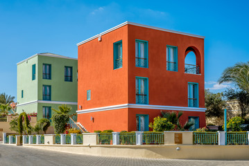 lime green and ocher colored houses in the sunshine