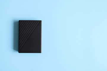external hard drive black color on blue background. space for text