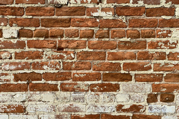 weathered peeling paint red brick wall distance view