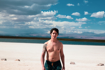 man walking through a turquoise landscape