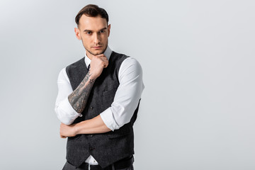 pensive handsome tattooed elegant bridegroom isolated on grey