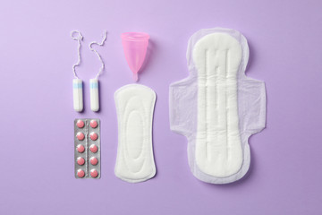 Flat lay with menstruation period concept on violet background, top view