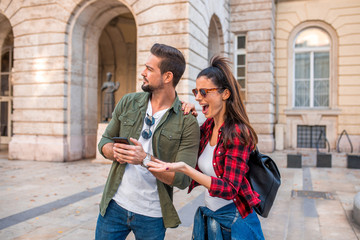 A couple trying to get orientation using a map on their mobile phone