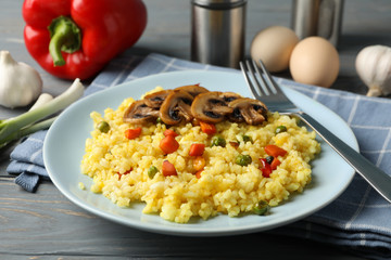 Composition with delicious rice on wooden background, close up