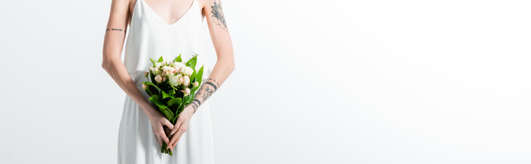 cropped view of tattooed bride with floral bouquet on white, panoramic shot