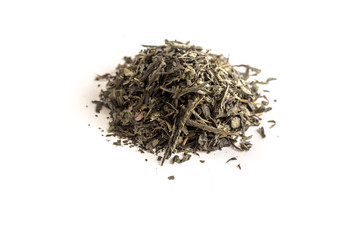 different sorts of black or green tea in bulk  on a white background close-up isolated