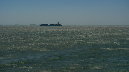 Ocean waves crashes on the rocks, windy weather on ocean.