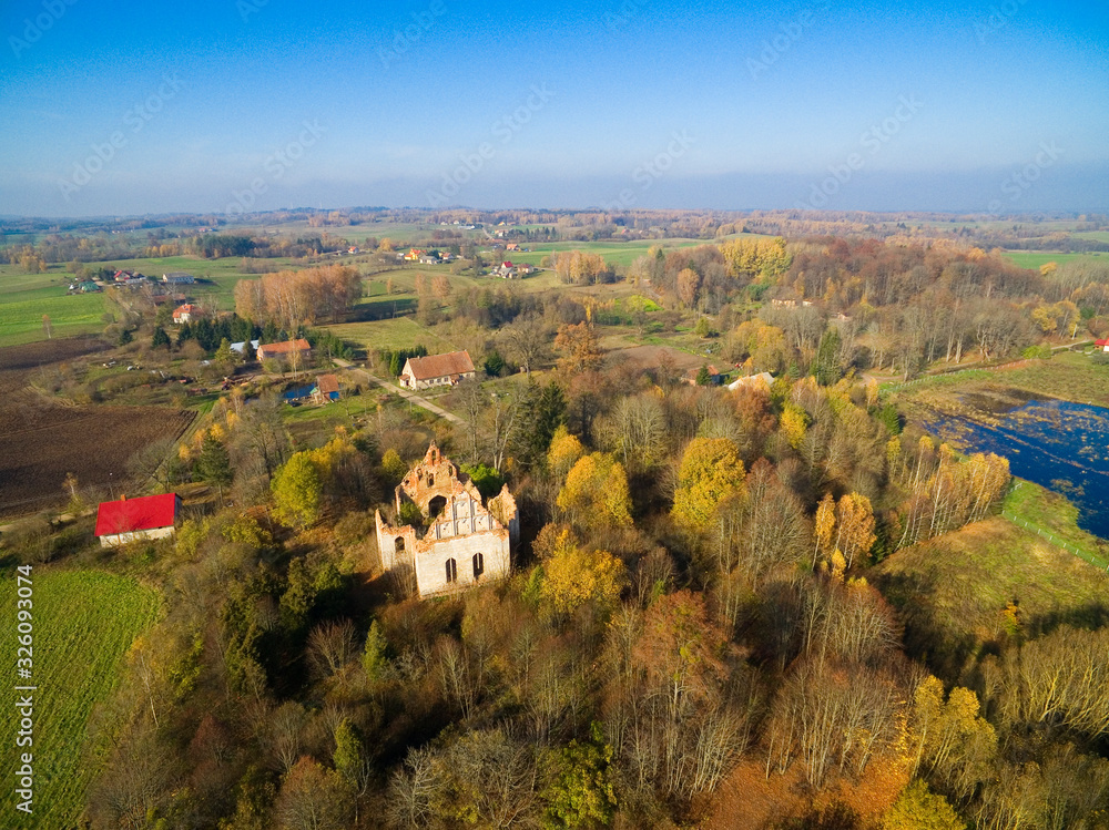 Wall mural Ruins of cross shaped Lutheran church in autumn scenery, Gorne, Poland (former Gurnen, East Prussia)