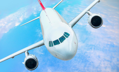White passenger airplane in the clouds  - Travel by air transport