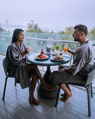 Breakfast on Balcony with a look over Pattaya Thailand, couple having breakfast on balcony with seaview