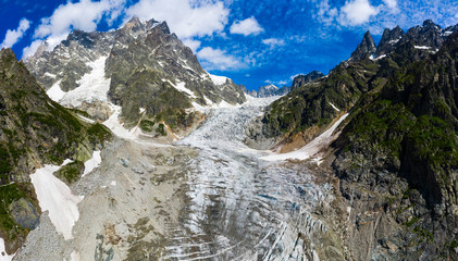 Caucasus Mountains on the border of Russia and Georgia. Chalaat Pass and Very beautiful view of the Chalaadi Glacier, Mount Ushba and Mestiachala river with background of clear blue sky.