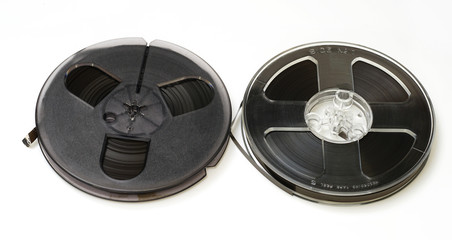Vintage magnetic audio reel on white background.