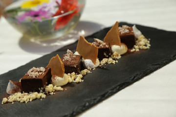 Dark chocolate dessert on stone slab