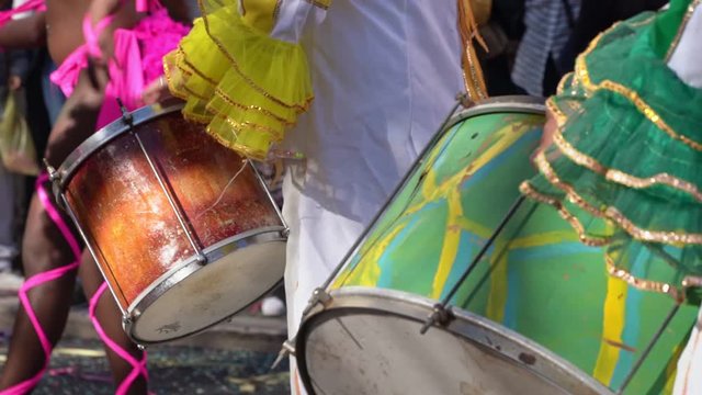 Drummer plays samba on the drum, at the carnival, slow motion, closeup.