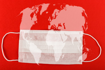 Medical protective mask on red background with World map.