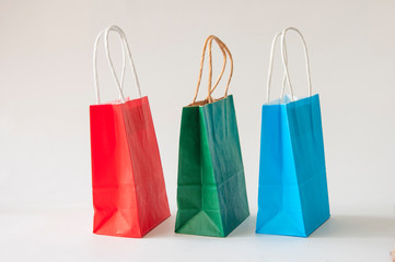 colorful paper bags with handles on a white background