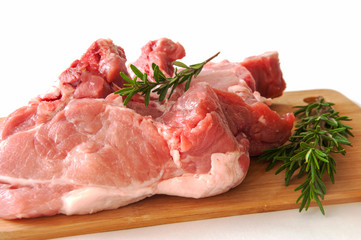 Raw pork fillet on a cutting board on a white background