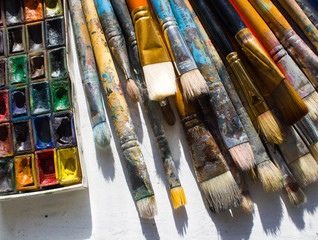 Workplace painter palette with colors and brushes. Palette of colors, creative disorder, art.