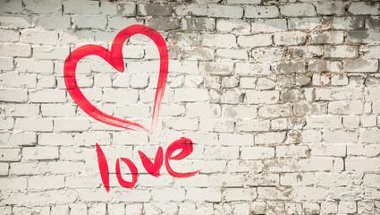 Painted heart contour on a white brick wall background