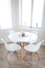 Easter table with spring blooming cherry twigs and Easter cake