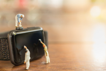 Technology, Time Concept. Close up of group of worker and painter miniature figure people clean and...