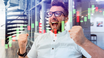 Excited Young Male Stock Market Broker. Success. Technical price graph and indicator, red and green candlestick chart and stock trading computer screen background. Double exposure.