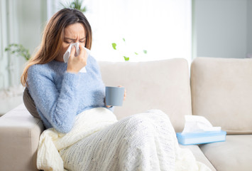 Young woman suffering from cold.