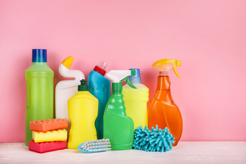 Set of cleaning products on pink background