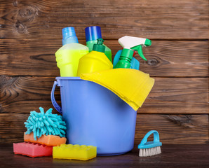 Set of cleaning products on wooden background