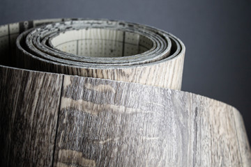 Obraz na płótnie Canvas Roll of linoleum with a wood texture. Linoleum cutting. Floor coverings.