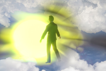Obraz premium silhouete of a man with rays of light emanating as a symbol of the power of thinking. Concept of psychiatry, psychology, religion. Ghost of a man taken up into heaven. 3d render