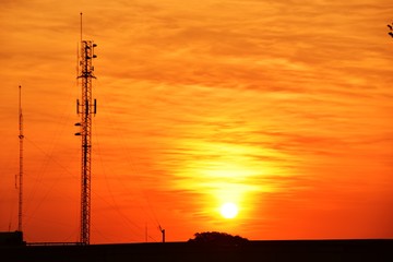 Wireless telephone pole and orange-yellow sky In the early morning of the day	