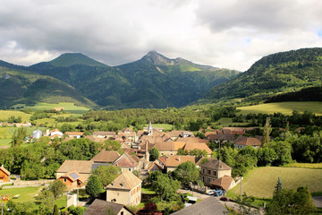Beautiful green landscape of old town in France, Alpine with old small buildings with tiled roofs