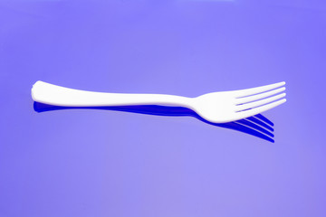 Plastic fork for casual food. White fork.