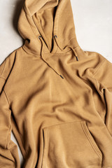 Beige color hoodie, top view. Casual clothing.