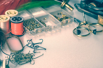 closeup set of different accessories for knitting flies for fly fishing