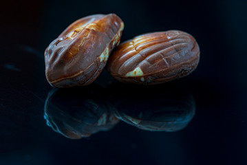 Swiss chocolate shaped shells on a dark mirror background.