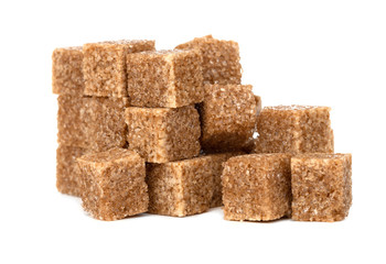 Cane sugar on a white background. Cane sugar cubes close up.
