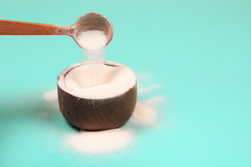 Collagen or protein in powder on teal background.