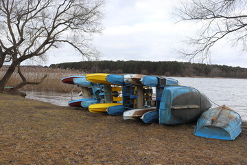 abandoned boats and catamarans on lake pier