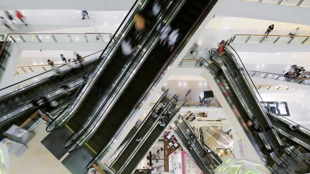 Time lapse 4k Escalators in modern of many tourism traveler people rush hour very busy for shop sale promotion store in shopping mall in building.