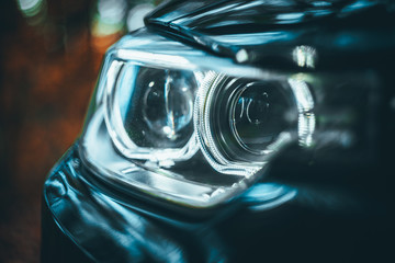 close up of white head lights of a car