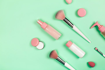 Care cosmetics in bottles on a delicate green background.